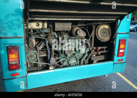 Broken down bus in high street with rear mounted engine cover raised to reveal diesel motor power unit awaiting breakdown repairs Essex England UK Stock Photo