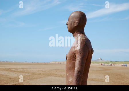 One of the iron men statues from Antony  Gormley's exhibit ' Another Place ' installed at Crosby Beach,  Liverpool in Merseyside Stock Photo