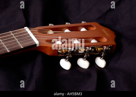 Acoustic guitar headstock on a black background Stock Photo