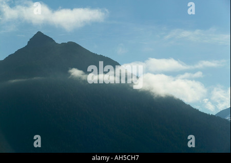 Arrowhead Peak 3275 ft silhouetted by early morning sunlight Sitka Alaska USA Stock Photo