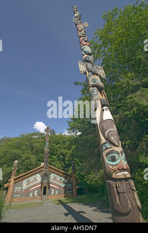 Tlingit Native American totem pole and clan house at Totem Bight State Park near Ketchikan Alaska USA Stock Photo