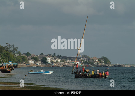 A busy sailing dhow transfers people from Manda Island to the Old Town on Lamu Island. Lamu Island, Kenya, Eastern Africa Stock Photo