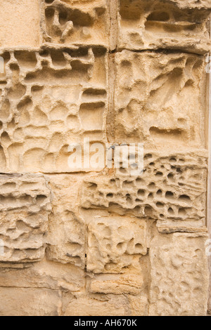 Eroded stonework on cottage wall Lacock Wiltshire Stock Photo