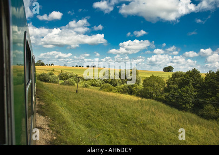 Train going through open Fields in Eastern Poland Warmia Suwalki Mazuria Stock Photo