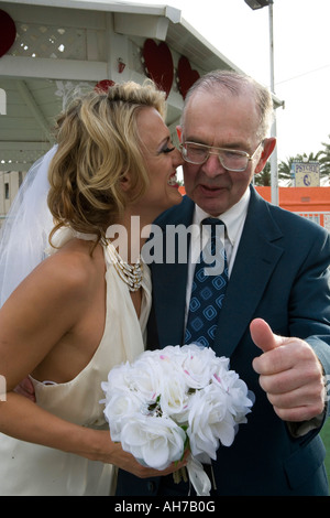 Bride smiling with a senior man giving a thumb's up Stock Photo