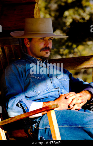 Mid adult man sitting in a rocking chair Stock Photo