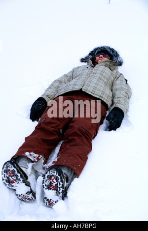 Young woman lying in the snow Stock Photo