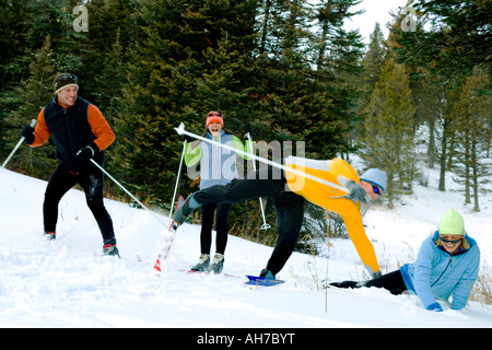 Two people skiing and two people falling Stock Photo
