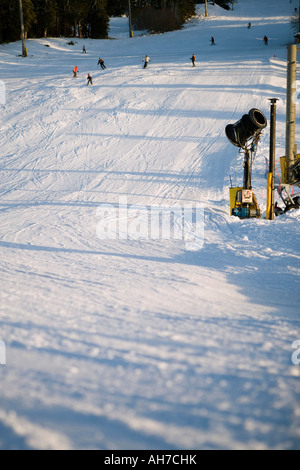 Group of people snowboarding down a hill Stock Photo