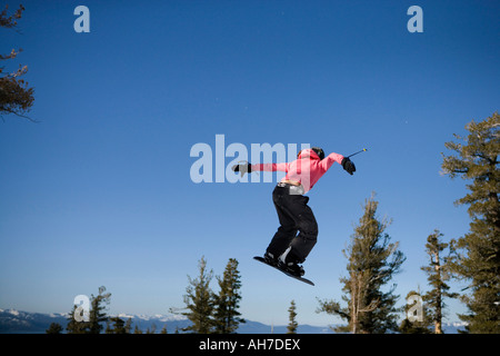 Young woman snowboarding Stock Photo