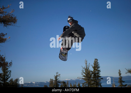 Young man snowboarding Stock Photo