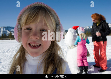 Portrait of a girl with her mother and sister in the background Stock Photo