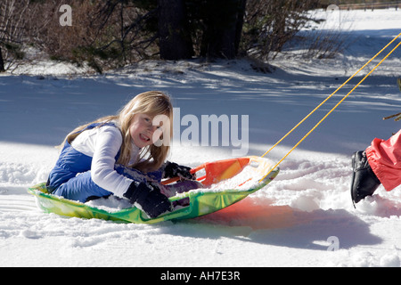 Girl riding on sled pulled by Siberian huskies. Sled dogs husky ...