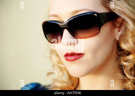 Close-up of a young woman wearing sunglasses Stock Photo