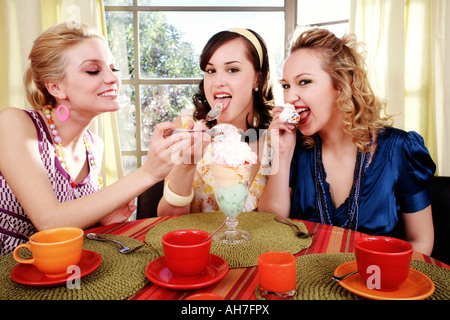 Three young women eating ice cream Stock Photo