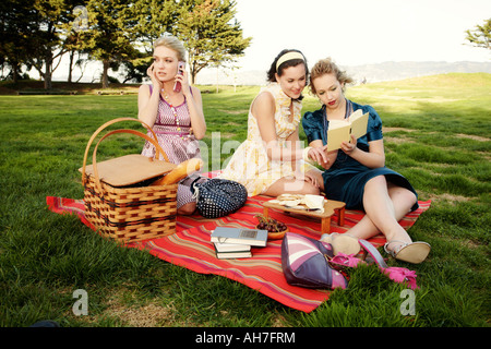 Three young women at a picnic Stock Photo