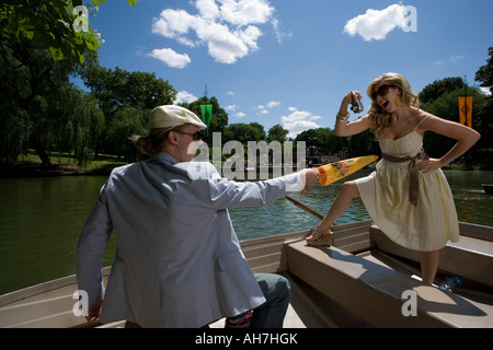 Young woman taking a picture of a young man in a boat, Central Park, Manhattan, New York City, New York, USA Stock Photo