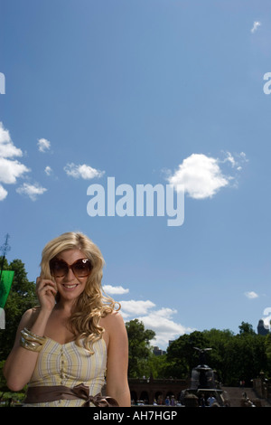 Young woman wearing sunglasses and smiling Stock Photo