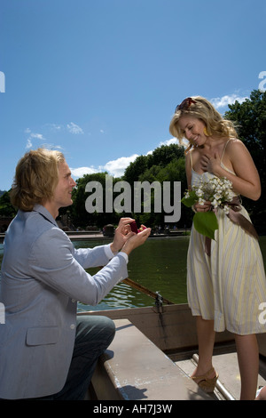 Young man proposing to a young woman and smiling, Central Park, Manhattan, New York City, New York, USA Stock Photo