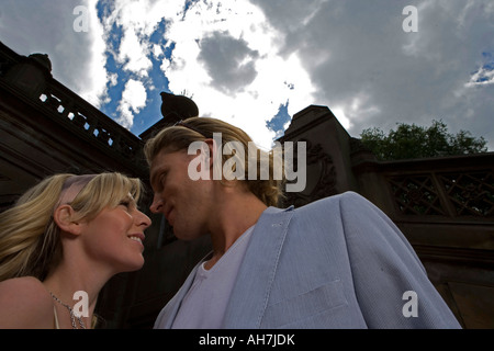 Low angle view of a young couple looking at each other and smiling Stock Photo