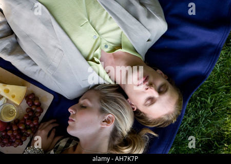 High angle view of a young couple napping in a park Stock Photo