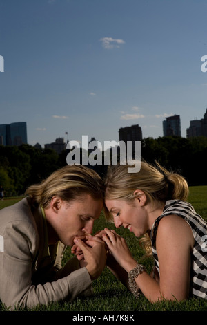 Young couple lying in a park and being romantic, Central Park, Manhattan, New York City, New York, USA Stock Photo