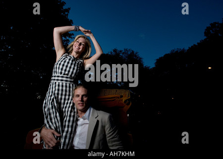 Young couple riding in a horsedrawn carriage Stock Photo