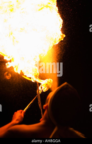 Fire breathing performer breathes flames Stock Photo