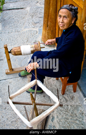 Old Dong Chinese Woman in Indigo Spinning Thread for Sewing Zhaoxing China Stock Photo