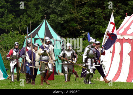 Knights in armour march from encampment at re enactment of a medieval battle at Cosmeston Medieval Village South Wales UK GB Stock Photo