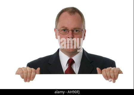 Businessman holding a blank sign space for your own text Isolated on white Stock Photo