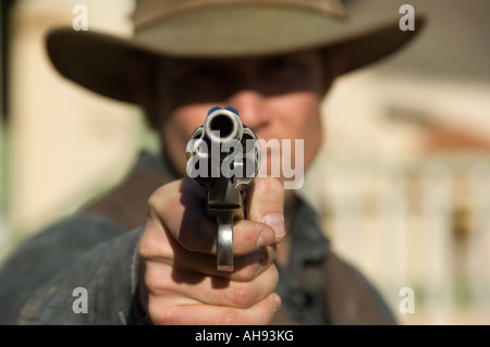 Cowboy holding revolver, close-up Stock Photo