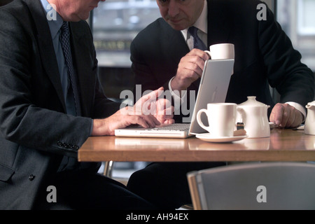 MEN WORKING IN CAFE Stock Photo