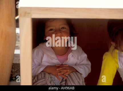 Children in Ecuador playing in a box Stock Photo