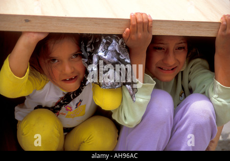 Children in Ecuador playing in a box Stock Photo