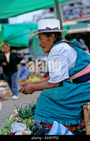 Indigenous woman selling produce at Sunday market in the village of Gualaceo near Cuenca Ecuador Stock Photo