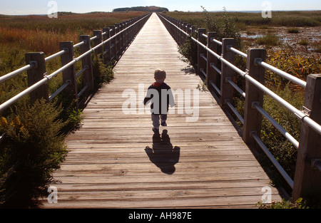 Small boy child walking on pathway into future Life Stock Photo