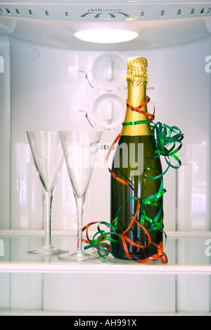 Bottle of champagne and two glasses in a refrigerator Stock Photo