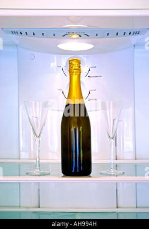 Bottle of champagne and two glasses in a refrigerator Stock Photo