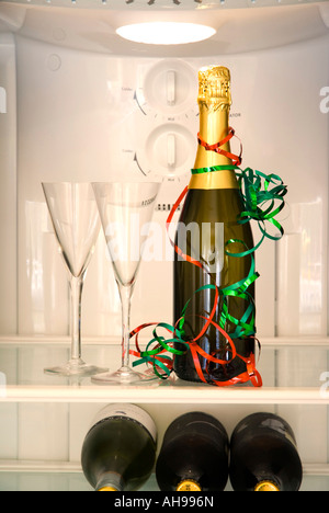 Bottle of champagne and two glasses in a refrigerator Stock Photo
