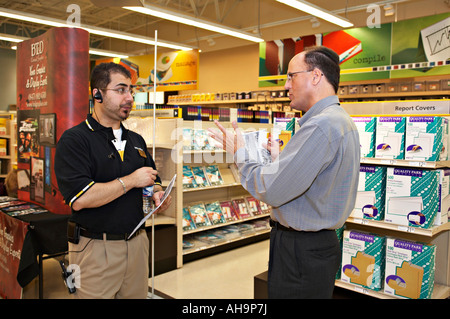 EVENT Hoffman Estates Illinois Male customer talk with male employee in OfficeMax store merchandise on shelves Stock Photo
