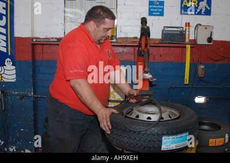 A Man Fitting A New Tyre Stock Photo