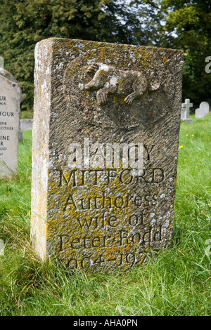 The grave of Nancy Mitford in the churchyard of St Marys church in the Cotswold village of Swinbrook, Oxfordshire UK Stock Photo