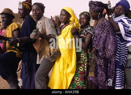 Dogon men and women dance in procession during a village celebration, Mali Stock Photo