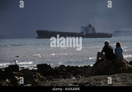 Sightseers looking out to the Napoli wreck off Branscombe beach Near Sidmouth Devon England UK Stock Photo