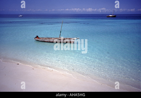 Paje beach and dugout boat on the clear coral reef, Bwejuu, Zanzibar island, Tanzania, East Africa Stock Photo