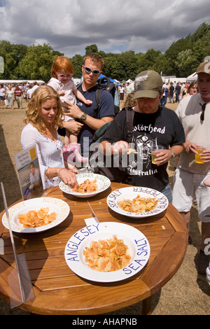 UK Hampshire Romsey Broadlands CLA Game Fair Food Village visitors eating Pipers crisps samples Stock Photo