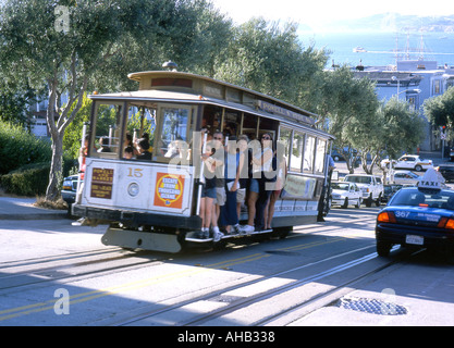 A cable car climbs a hill in San Francisco Stock Photo