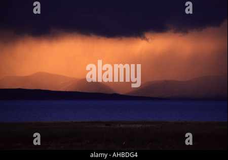 A vivid sunset over Lake Manasarovar at 4585m considered to be the highest freshwater lake in the world. Western Tibet Stock Photo