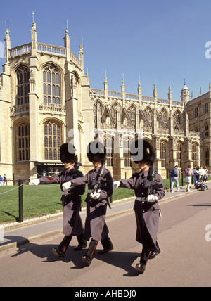 St Georges Chapel Windsor Castle Berkshire England UK British Army Grenadier guardsmen soldiers marching in winter uniform with Bearskin hat & plume Stock Photo